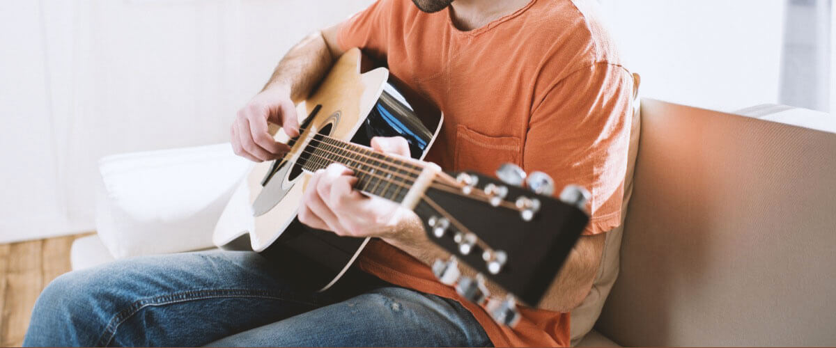 holding the guitar in lap